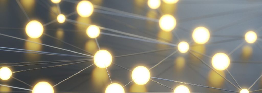 Zdjęcie przedstawiające połączone w sieć święcące kulki